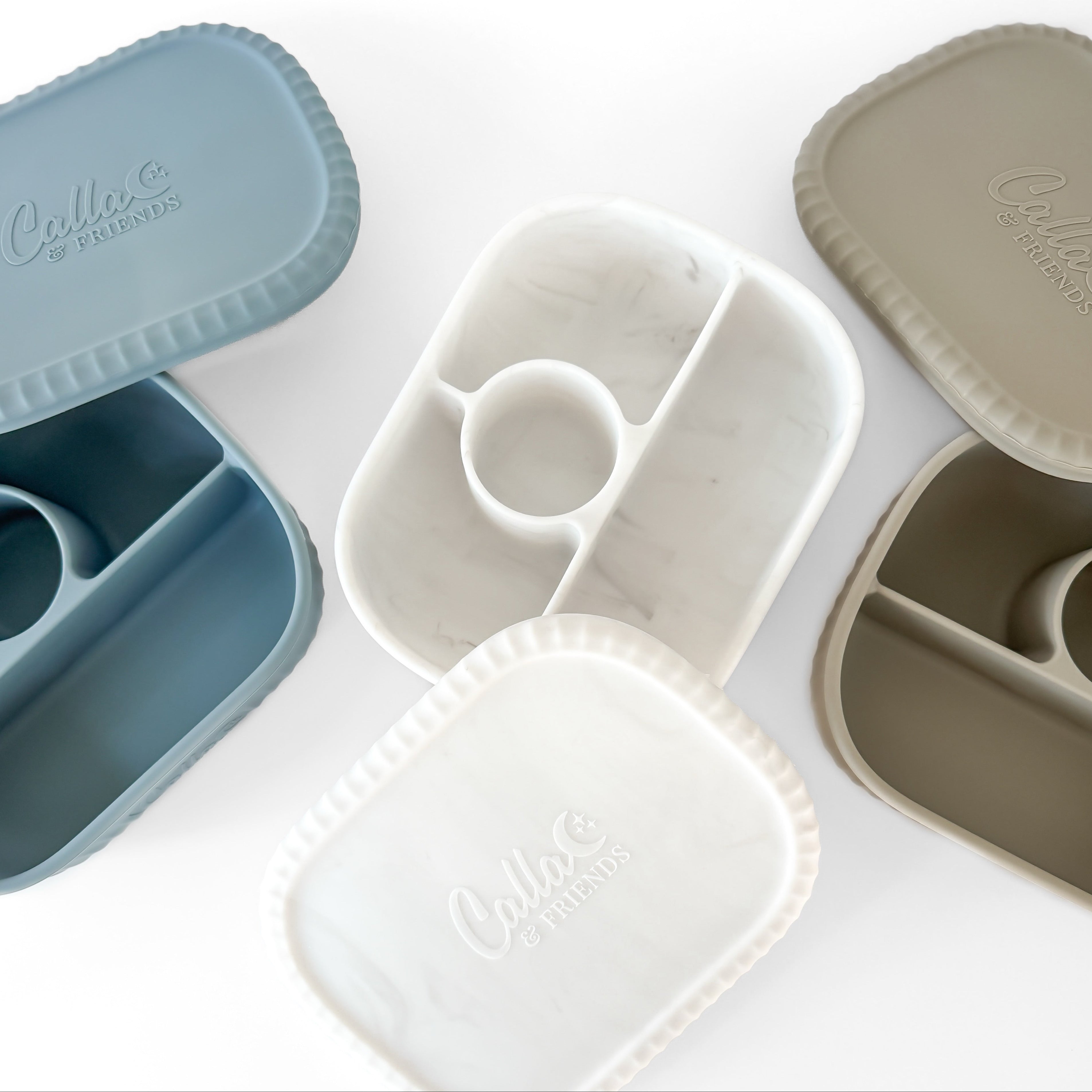 Set of three divided bento boxes in blue, marbled white, and pine green with 'Calla & Friends' branding on a white background.
